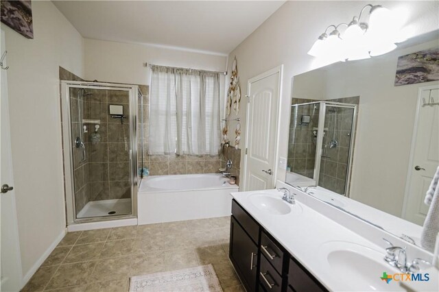 201 Boulder Ridge Dr, Cuero, TX 77954 - bathroom with a bath, a shower stall, double vanity, and tile patterned floors