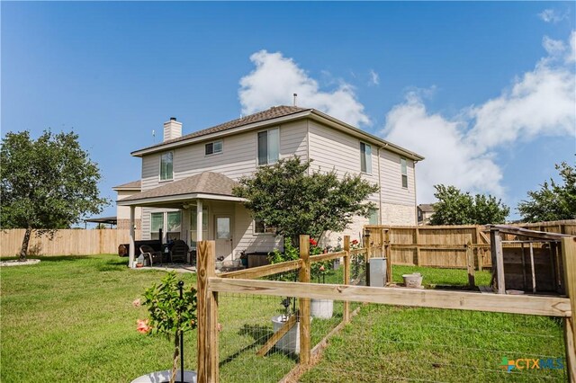201 Boulder Ridge Dr, Cuero, TX 77954 - back of house with a chimney