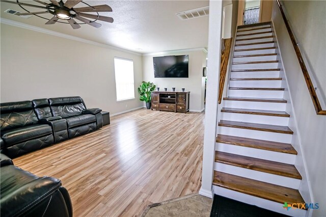201 Boulder Ridge Dr, Cuero, TX 77954 - living area featuring ornamental molding, a ceiling fan, stairs, wood finished floors, and baseboards