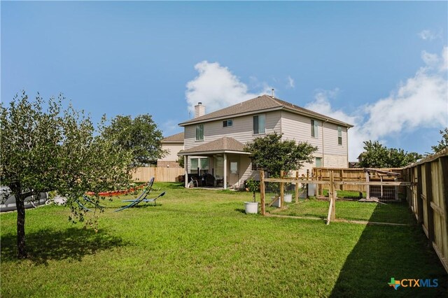 201 Boulder Ridge Dr, Cuero, TX 77954 - back of property with a gazebo, a chimney, and a shingled roof