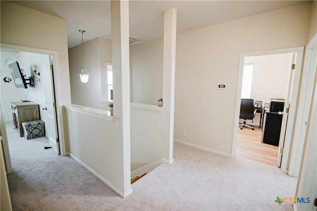 201 Boulder Ridge Dr, Cuero, TX 77954 - corridor with carpet, an upstairs landing, a desk, and baseboards