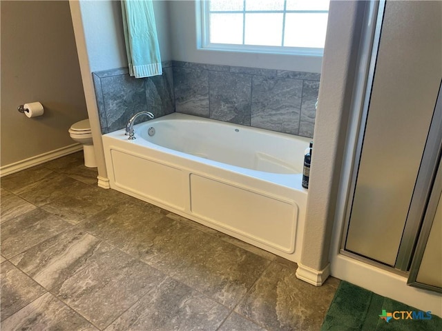 bathroom featuring shower with separate bathtub and toilet