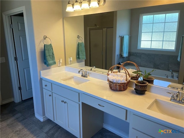 bathroom with vanity and shower with separate bathtub