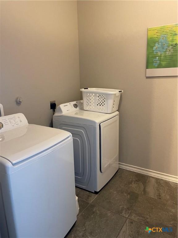 clothes washing area featuring washer and dryer