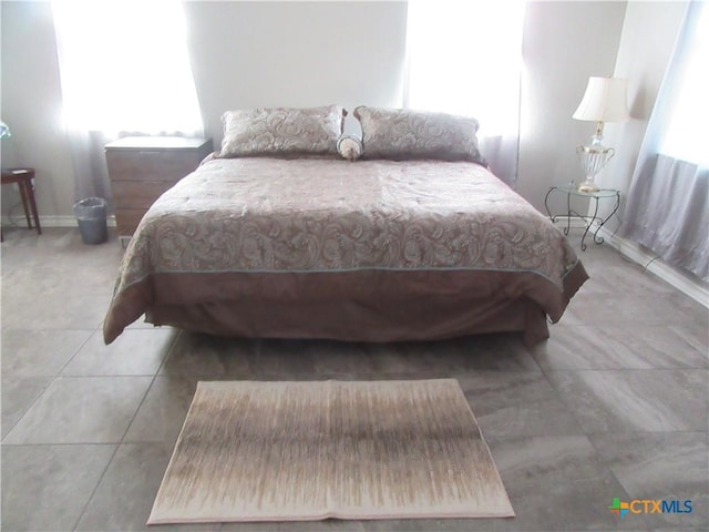 bedroom featuring light tile patterned floors