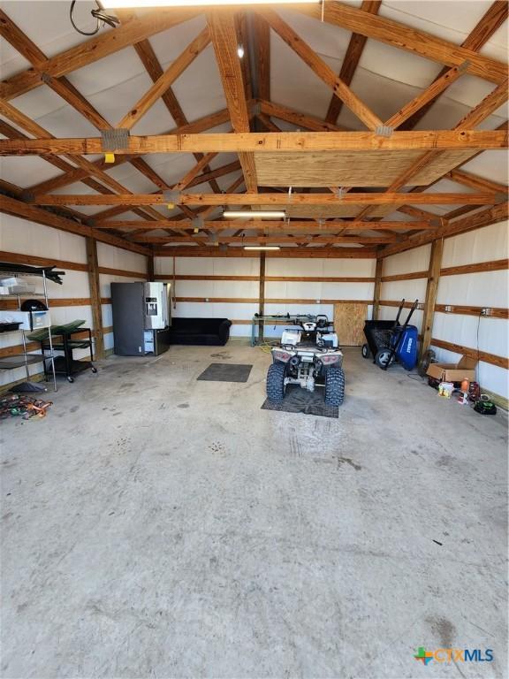 garage with stainless steel fridge with ice dispenser