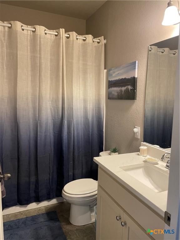 bathroom featuring vanity, toilet, and a shower with shower curtain