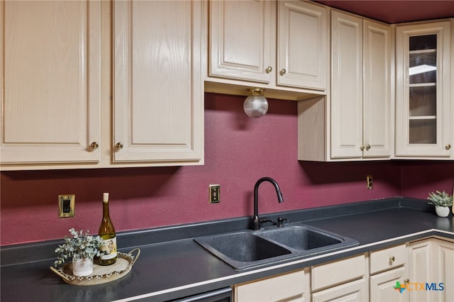 1062 Rolling Path, New Braunfels, TX 78130 - kitchen featuring dark countertops, a textured wall, and glass insert cabinets