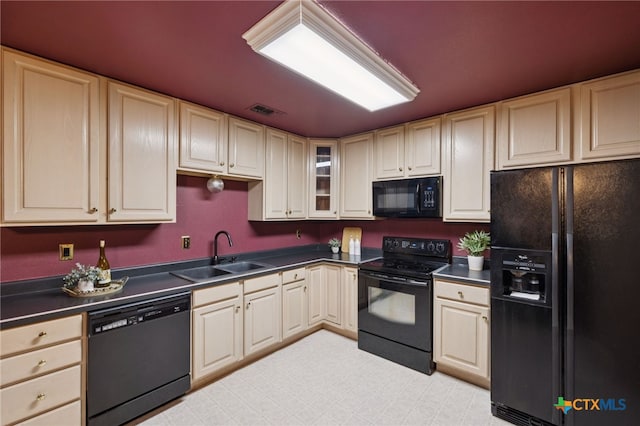 1062 Rolling Path, New Braunfels, TX 78130 - kitchen with black appliances, dark countertops, and cream cabinets