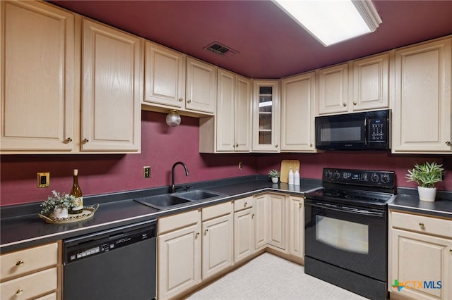 1062 Rolling Path, New Braunfels, TX 78130 - kitchen with black appliances, dark countertops, glass insert cabinets, and cream cabinetry
