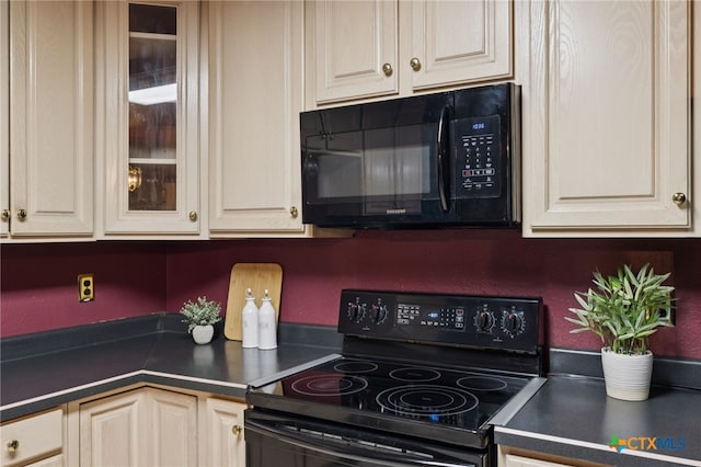 1062 Rolling Path, New Braunfels, TX 78130 - kitchen featuring black appliances, dark countertops, glass insert cabinets, and cream cabinetry