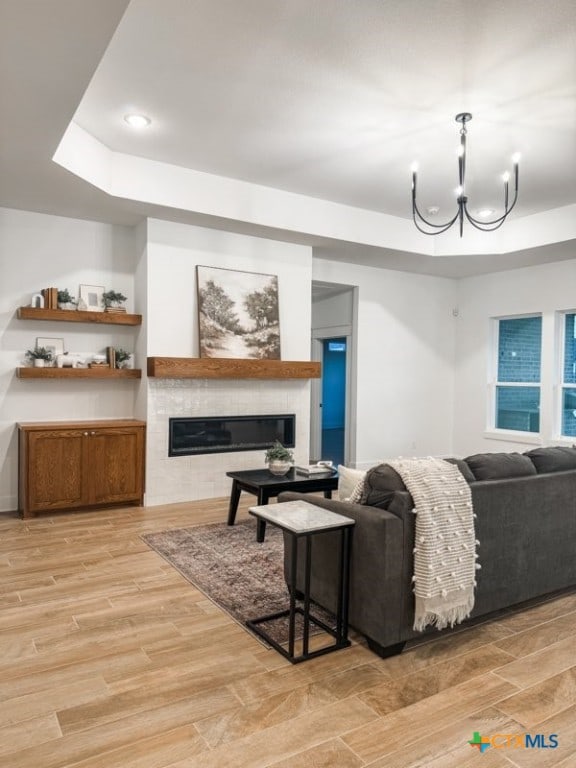 living room with light hardwood / wood-style flooring and a notable chandelier