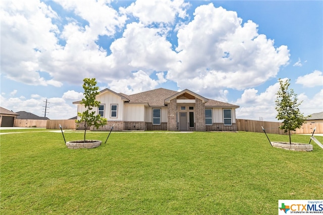 ranch-style house with a front yard and an outdoor fire pit