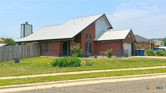 601 Barber Dr, Copperas Cove, TX 76522 - view of front of home featuring a standing seam roof, brick siding, a garage, and metal roof