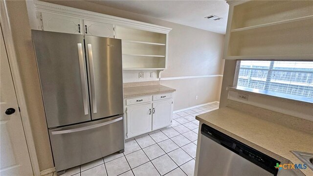 601 Barber Dr, Copperas Cove, TX 76522 - kitchen with stainless steel appliances, open shelves, light tile patterned flooring, white cabinets, and light countertops