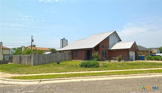 601 Barber Dr, Copperas Cove, TX 76522 - view of front of property featuring brick siding, an attached garage, metal roof, driveway, and a standing seam roof