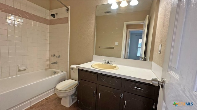 601 Barber Dr, Copperas Cove, TX 76522 - full bathroom with a textured wall, toilet, washtub / shower combination, tile patterned flooring, and vanity
