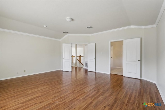 unfurnished bedroom with wood finished floors, crown molding, and baseboards