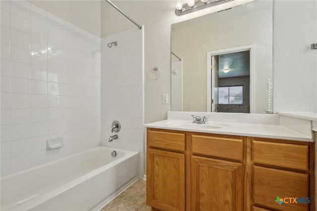 full bath featuring bathtub / shower combination, vanity, and tile patterned flooring