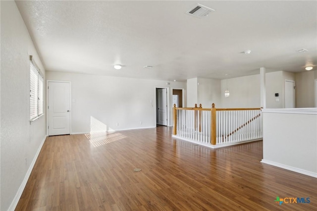 unfurnished room featuring baseboards and wood finished floors