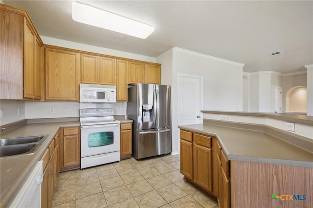 kitchen featuring white appliances, ornamental molding, light tile patterned flooring, and a sink