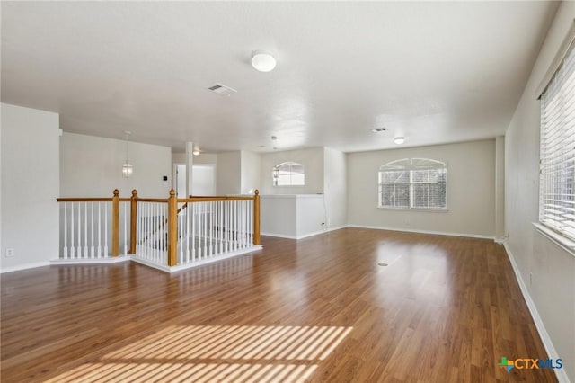 empty room with wood finished floors and baseboards