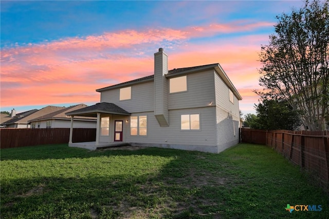 rear view of house with a chimney and a patio