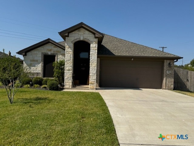 1802 Rustic Manor Dr, Temple, TX 76502 - french country style house featuring stone siding, an attached garage, and concrete driveway