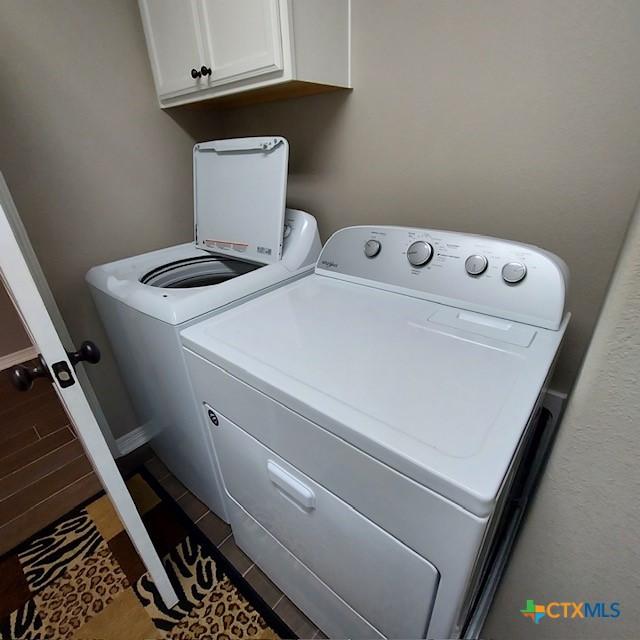1802 Rustic Manor Dr, Temple, TX 76502 - laundry area with washer and dryer and cabinet space