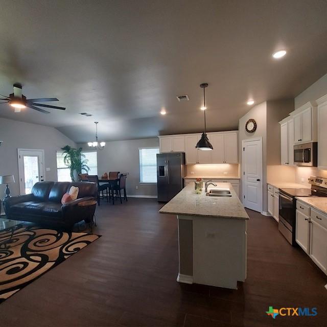 1802 Rustic Manor Dr, Temple, TX 76502 - kitchen with appliances with stainless steel finishes, ceiling fan, dark wood-style flooring, open floor plan, and white cabinets