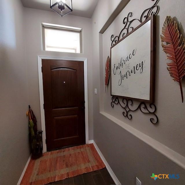 1802 Rustic Manor Dr, Temple, TX 76502 - doorway with wood finished floors and baseboards