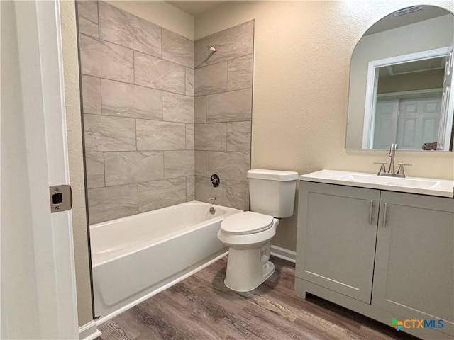 708 E 5th St, Nixon, TX 78140 - full bathroom with wood finished floors, shower / bathtub combination, vanity, and a textured wall