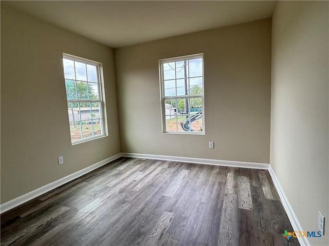 708 E 5th St, Nixon, TX 78140 - empty room with dark wood-style flooring and baseboards
