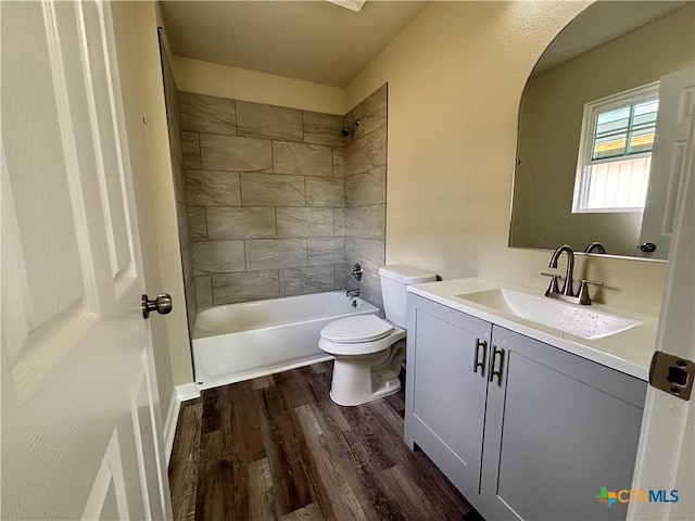 708 E 5th St, Nixon, TX 78140 - full bath featuring vanity, wood finished floors, and shower / washtub combination