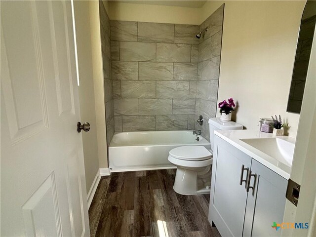708 E 5th St, Nixon, TX 78140 - bathroom featuring vanity, wood finished floors, and shower / bathtub combination