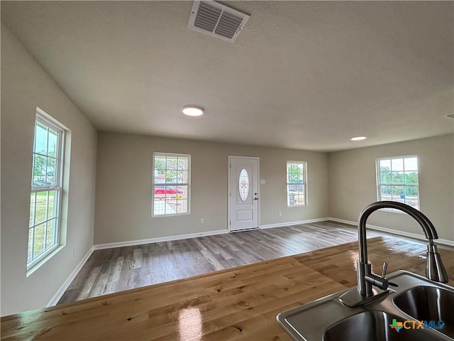 708 E 5th St, Nixon, TX 78140 - foyer entrance featuring wood finished floors and baseboards