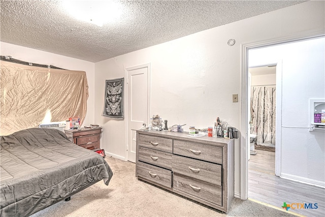 carpeted bedroom featuring a textured ceiling