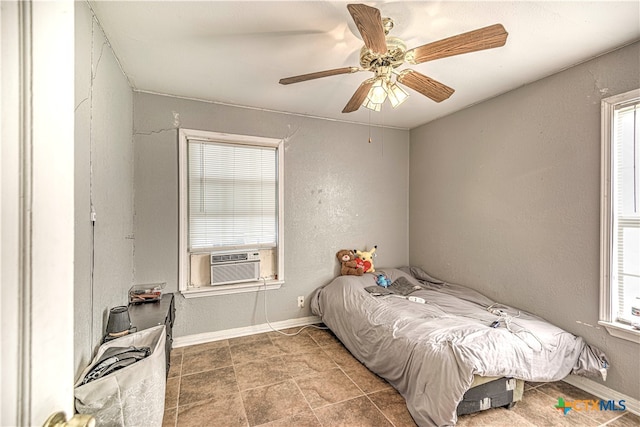 bedroom with ceiling fan and cooling unit