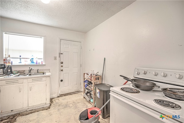 kitchen with white range with electric stovetop, white cabinetry, and a textured ceiling