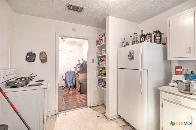 kitchen with white cabinets, white appliances, a textured ceiling, and light wood-type flooring