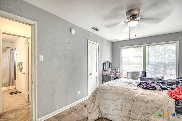 tiled bedroom with ceiling fan