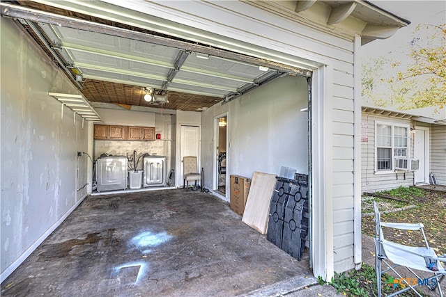 garage with a garage door opener and washing machine and dryer