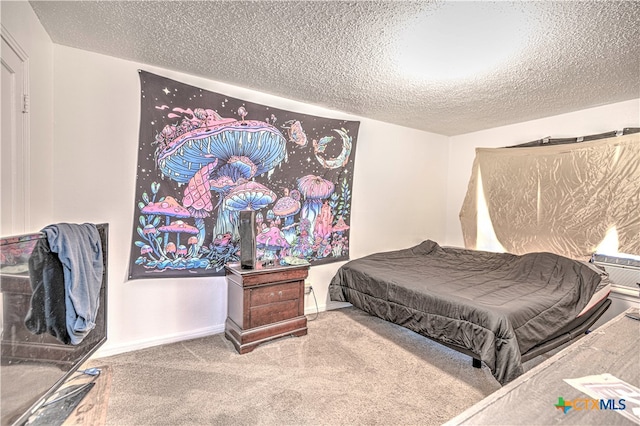 bedroom with carpet flooring and a textured ceiling