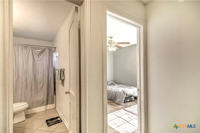 bathroom with ceiling fan, tile patterned floors, and toilet