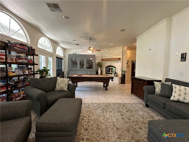 tiled living room featuring pool table, a fireplace, and ceiling fan