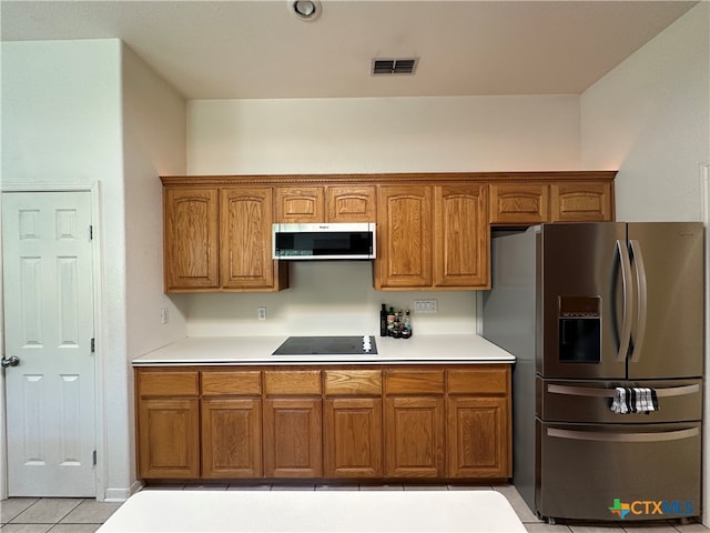 kitchen with appliances with stainless steel finishes and light tile patterned flooring