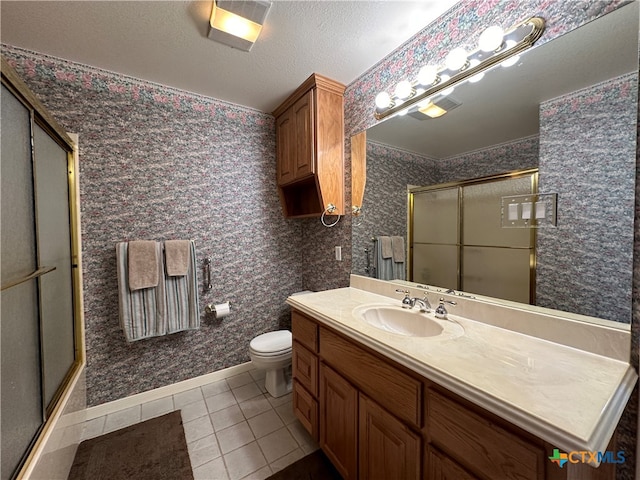 bathroom with toilet, a shower with door, tile patterned flooring, a textured ceiling, and vanity