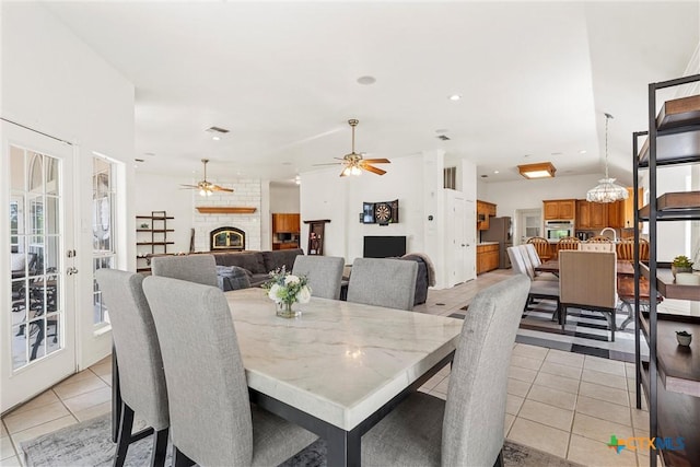 living room featuring ceiling fan, visible vents, a textured ceiling, and light tile patterned floors