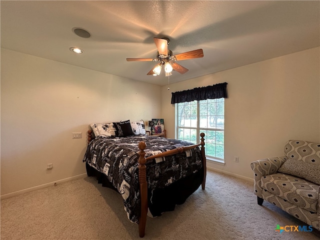 bedroom with ceiling fan and light colored carpet