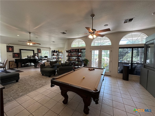 playroom featuring pool table, ceiling fan, a textured ceiling, light tile patterned floors, and french doors